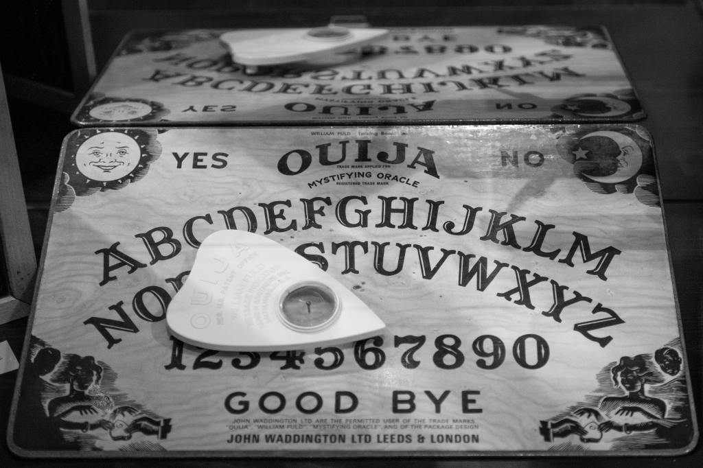 Greyscale photo of a Ouija board